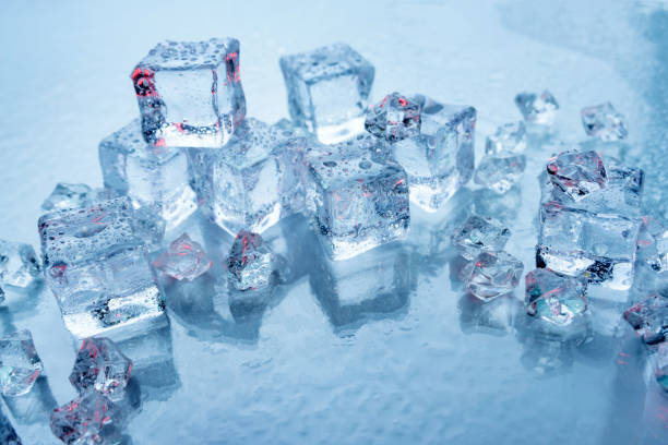 istock Chunks of ice for drinks on a blue background 1283983046
