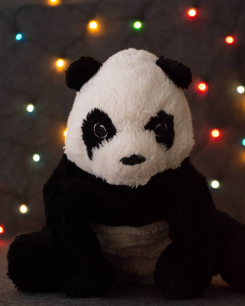 istock little panda bear toy on garland background 1283985788