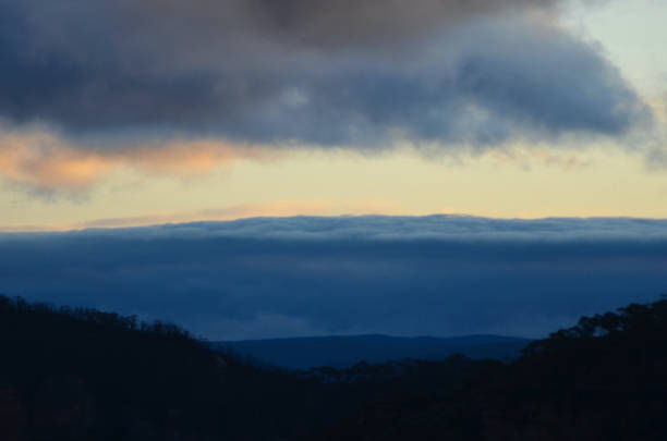 istock A bank of storm clouds rolling over a forest at dusk. 1283985793