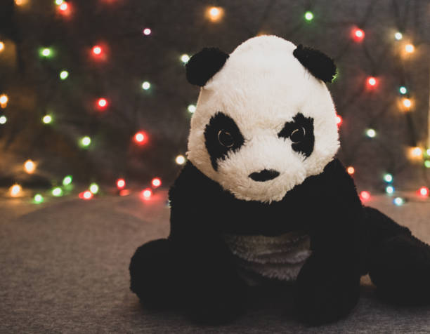 little panda bear toy on garland background