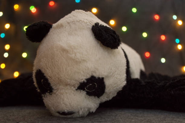 istock little panda bear toy on garland background 1283986592