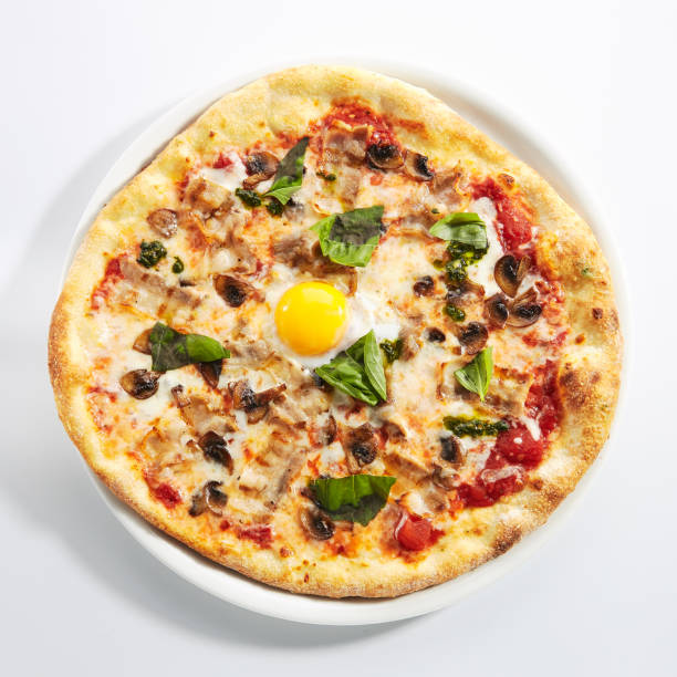 istock Pizza with Mushrooms, Bacon and Egg in Restaurant Plate Isolated 1283986770