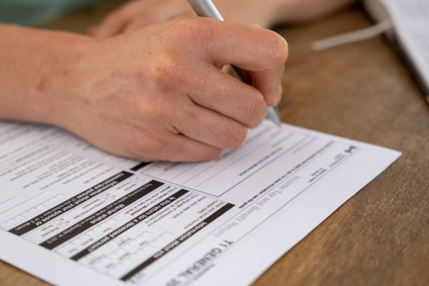 istock Young male completing his Canadian TAX return 1283987440