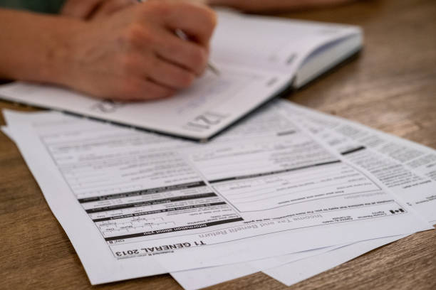 istock Young male completing his Canadian TAX return 1283987552