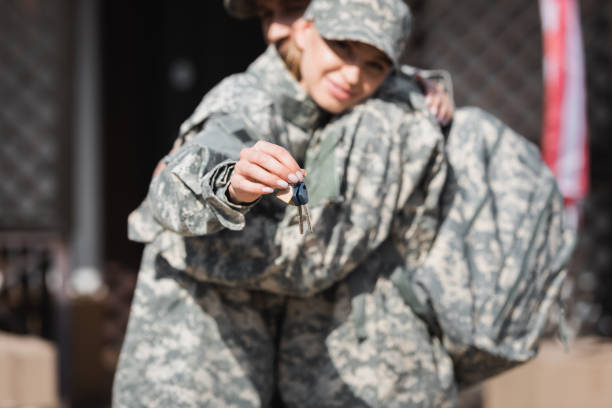 istock Keys with blurred military wife and husband hugging on background 1283988693