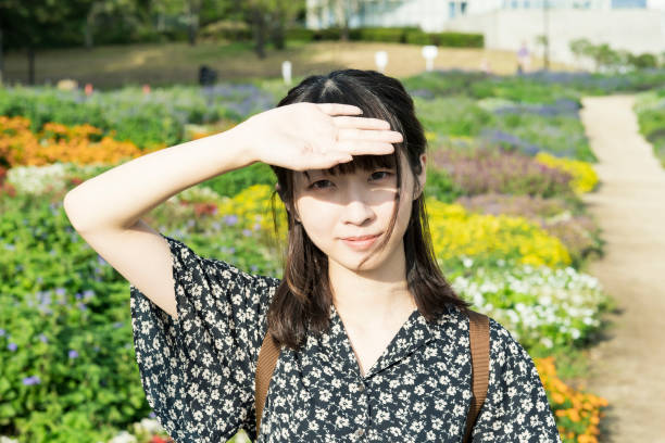 istock Young Asian woman blocking sunlight 1283990476