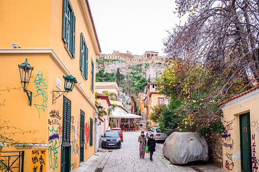 Athens / Greece - February 1 2014: View of Plaka, the old historical neighbourhood clustered around slopes of the Acropolis, with labyrinthine streets and neoclassical architecture.