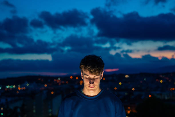 istock Young man with evening city views 1283991410