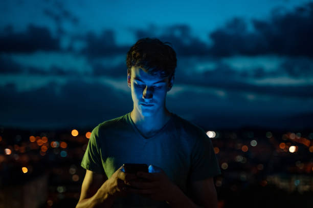 istock Teenager using smartphone at twilight 1283991426
