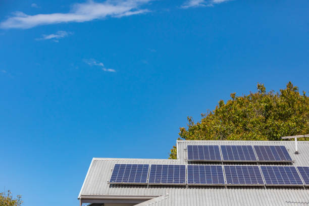 istock Solar Panels on a House Roof With a Clear Blue Sky 1283992265