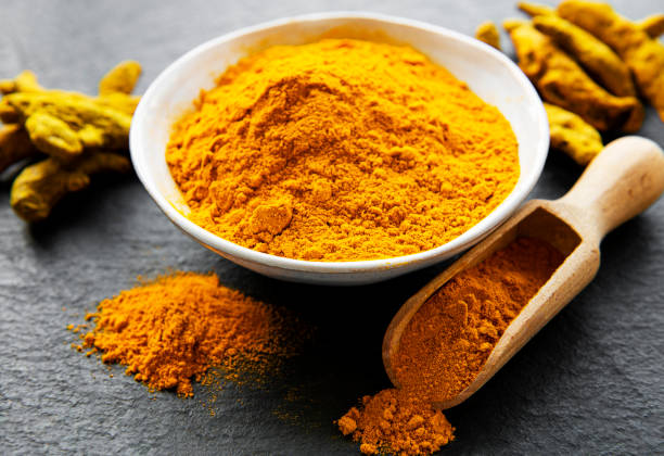 istock Turmeric powder and dry roots 1283993447