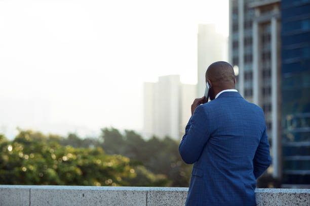 istock Confident man talking on the phone with scenic view 1283993521