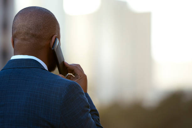 istock Confident man talking on the phone with scenic view 1283993527