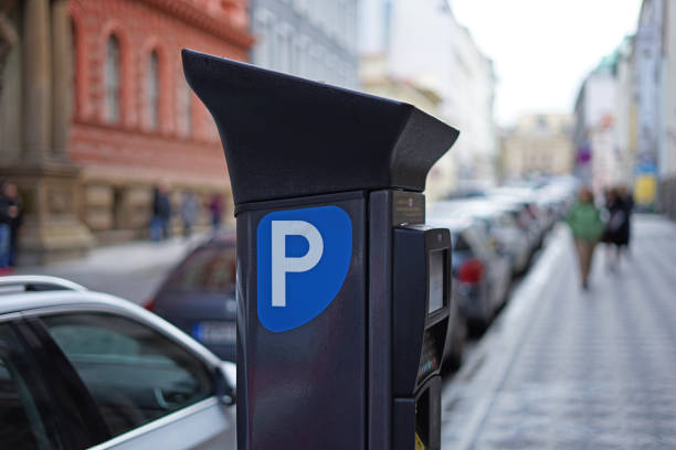 istock Modern solar car parking pay station on a busy street 1283993832