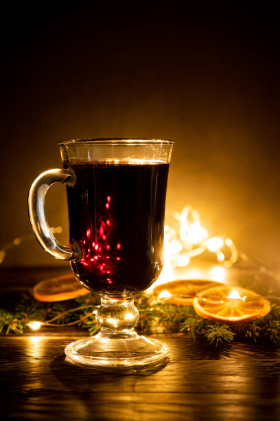 istock Mulled wine with cinnamon and an orange and fur-tree branches, a New Year's still-life 1283994752