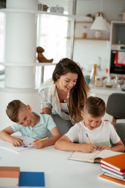 istock Mother helping her son with homework at home. 1283994906