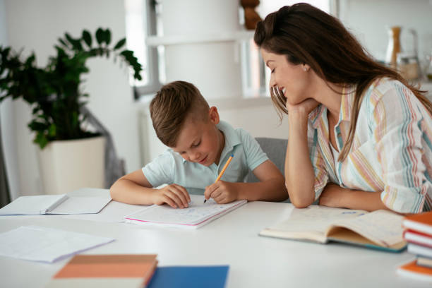 istock Mother helping her son with homework at home. 1283994989