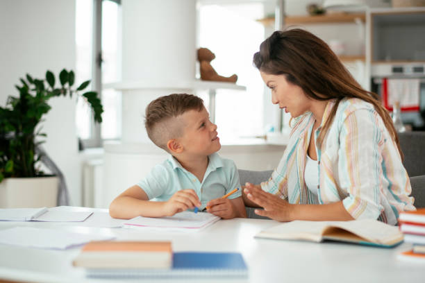 istock Mother helping her son with homework at home. 1283995044
