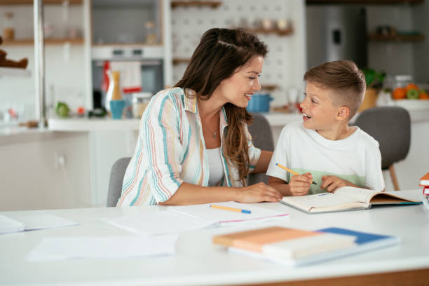 istock Mother helping her son with homework at home. 1283995045