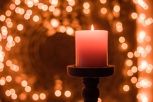 Burning candle light decoration with glitter bokeh  background