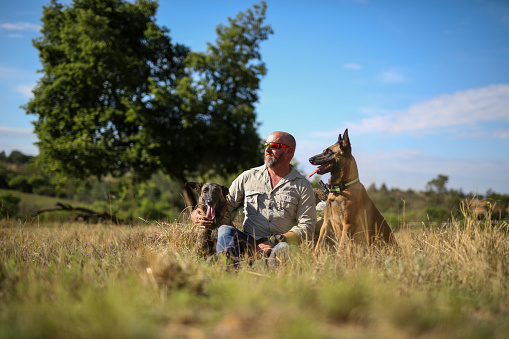 A game ranger with his dogs. He is training them to work in a anti poaching unit.
