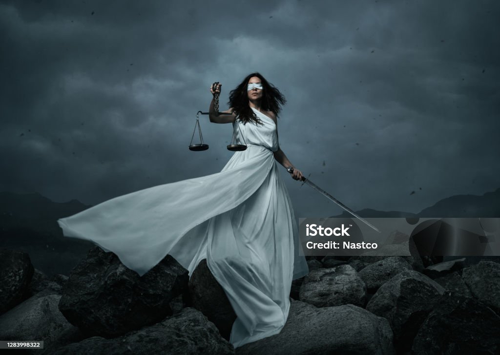 Young fairly woman with scale and sword over the dramatic sky Young fairly woman with scale and sword over the dramatic sky with copy space Lady Justice Stock Photo