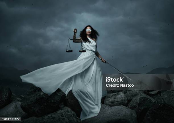 Young Fairly Woman With Scale And Sword Over The Dramatic Sky Stock Photo - Download Image Now