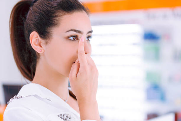 Young woman insert contact lens