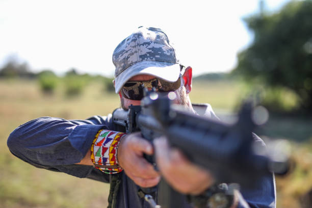 istock A game ranger aiming thru a rifle 1283999125