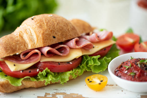 istock french croissant with ham, cheese, tomato and salad 1283999925
