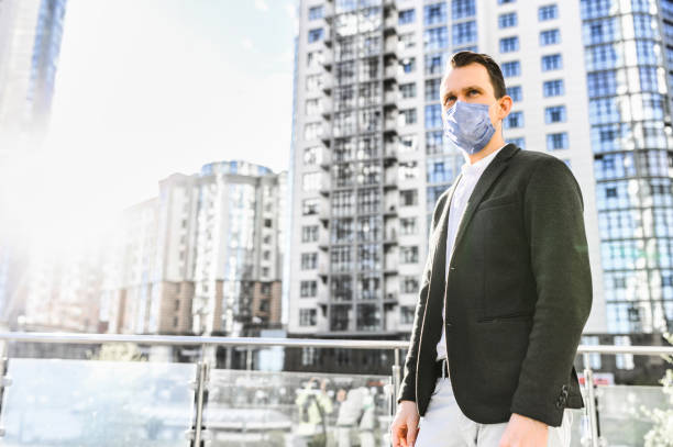 istock Man in smart casual wear with a protective mask 1284000060