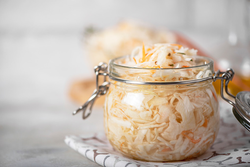 fermented cabbage with carrots, spices and seasonings in glass jar