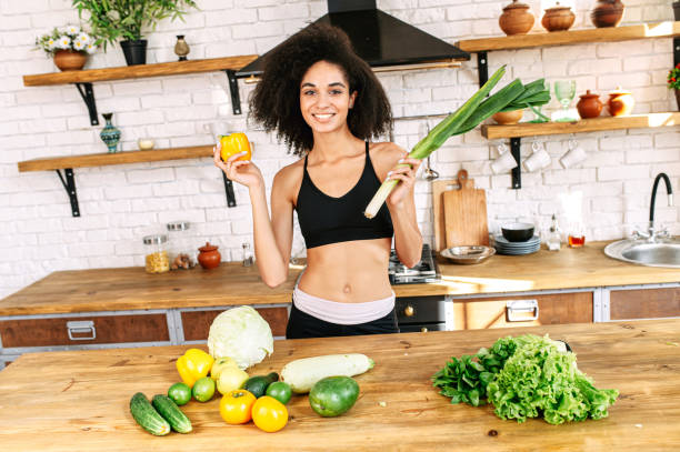 istock A healthy woman with a vegetables at kitchen 1284000199