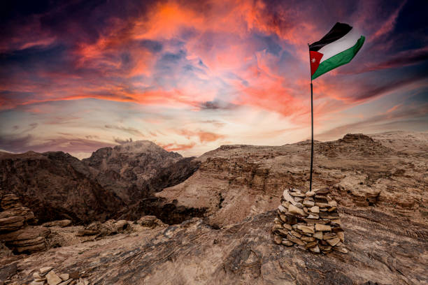 istock jordan flag on the mountains near petra. 1284003012
