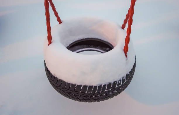 Tire swing on the children playground covered in a layer of deep snow, Tromso, Norway