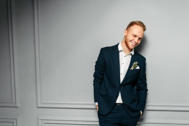 istock Elegant and attractive red-haired guy in a suit 1284003614