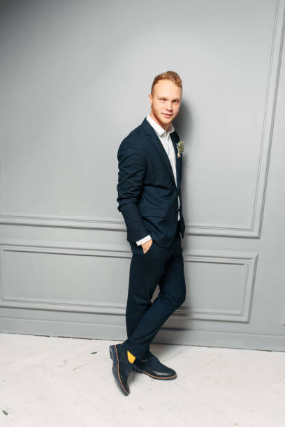 istock Elegant and attractive red-haired guy in a suit 1284003615