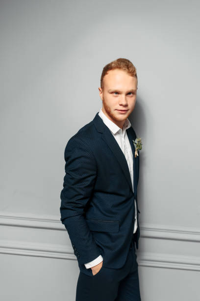 istock Elegant and attractive red-haired guy in a suit 1284003640
