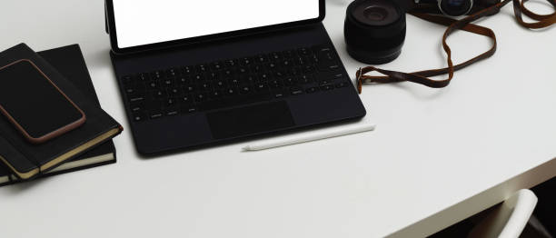 istock Workspace with tablet, keyboard, notebooks, smartphone and lens camera, clipping path 1284004169