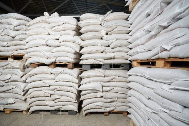 istock Many white full bags with cereals lie on pallets in a warehouse 1284004803