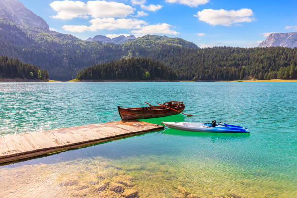 Lonely boats in the Black Lake on Mount Durmitor, Montenegro Lonely boats in the Black Lake on Mount Durmitor, Montenegro. durmitor national park photos stock pictures, royalty-free photos & images