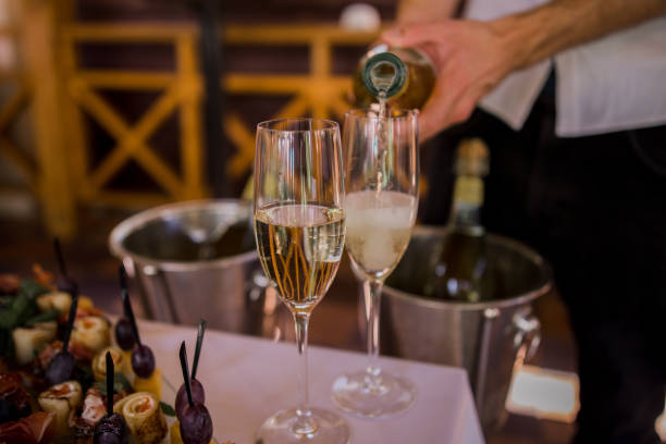 istock the waiter pours champagne into a glass 1284006537