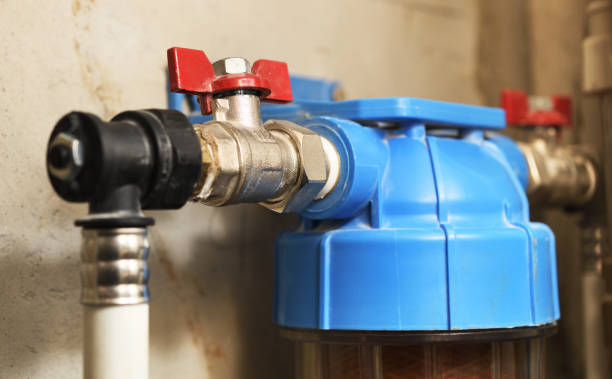 istock Plastic 10 Inch Single Water Filter, Wall Mounted Water Purifier Body Mounted On A Concrete Wall In A New Building. 1284006613