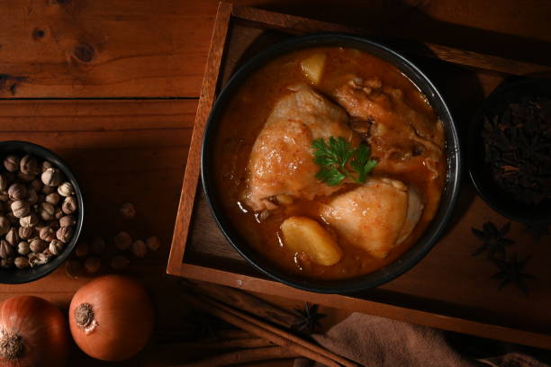 istock Chicken Massaman Curry soup with ingredients on wooden table 1284006968
