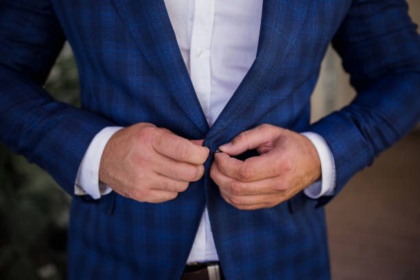 istock a man in a suit buttons the button of his jacket 1284007118