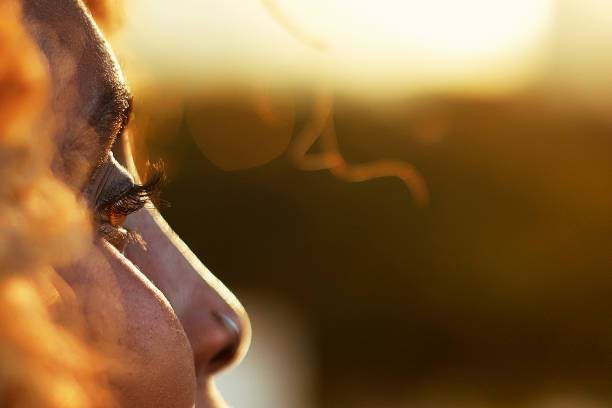 Golden hour closeup of woman's eye Closeup of beautiful woman's eye looking out over the city at sunset golden hour photos stock pictures, royalty-free photos & images