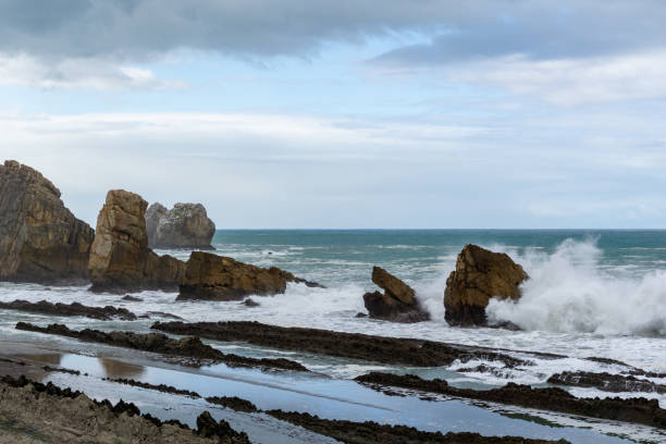 istock rocky and wild coast with stormy waves hitting the shore 1284008040