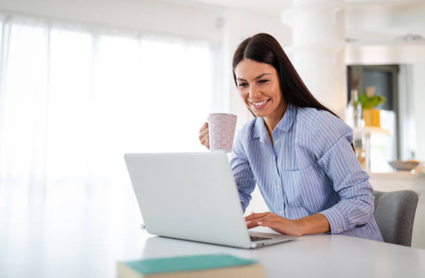 istock Woman with notebook in the kitchen. Working from home in quarantine lockdown. Social distancing 1284008111