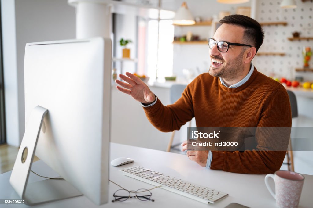 Man having video conferencing call via computer. Working remotely managing team and work from home Young man having video conferencing call via computer. Working remotely managing team and work from home Home Video Camera Stock Photo