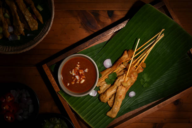 istock Grilled pork satay (Moo Satay) with cucumber and onion served with peanut sauce 1284008417